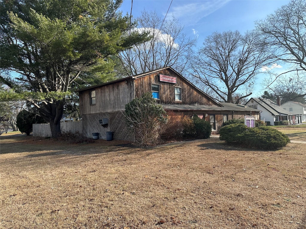 view of property exterior with a lawn