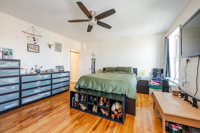 bedroom featuring ceiling fan, a closet, and light wood-type flooring