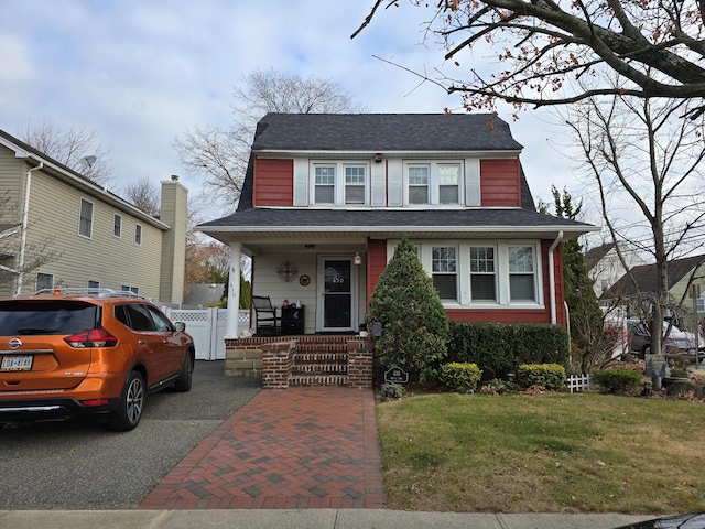 view of front of property featuring covered porch and a front yard