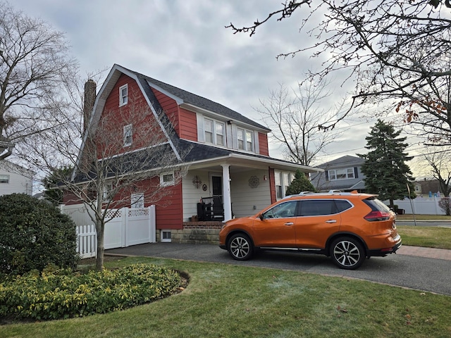 view of side of home with a yard