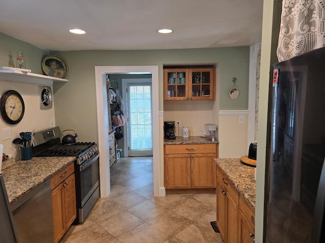 kitchen featuring light stone counters and stainless steel appliances