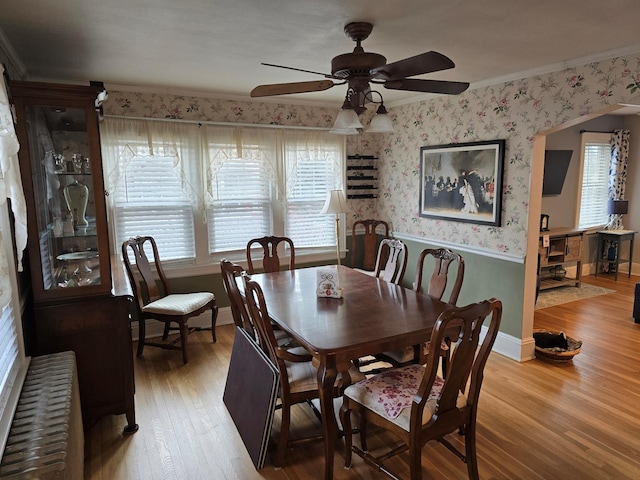 dining area featuring hardwood / wood-style floors, crown molding, ceiling fan, and a healthy amount of sunlight