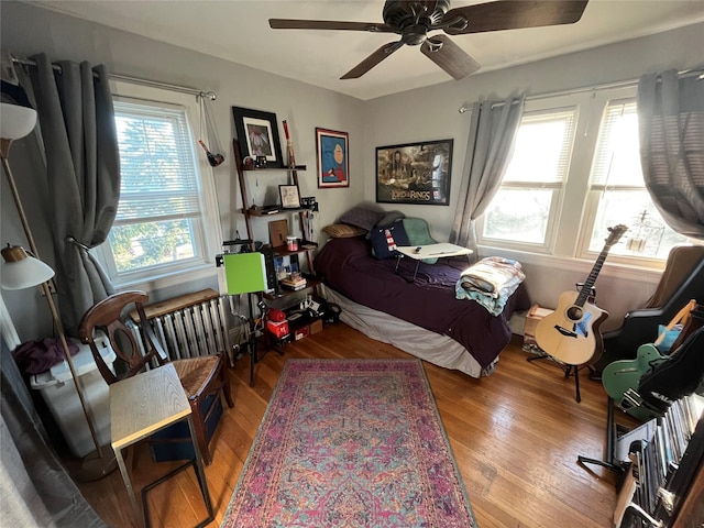 bedroom with ceiling fan and wood-type flooring