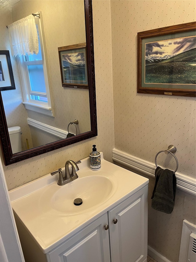 bathroom featuring vanity and toilet