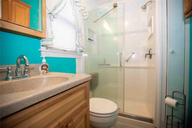 bathroom with vanity, toilet, and an enclosed shower