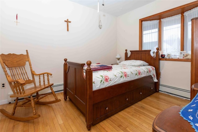 bedroom featuring a baseboard radiator and light hardwood / wood-style floors