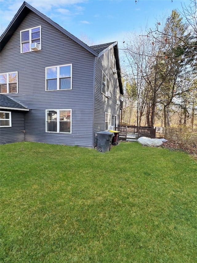 view of side of home with a lawn and a deck