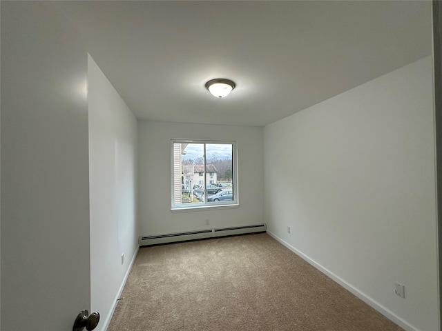 carpeted spare room with baseboard heating