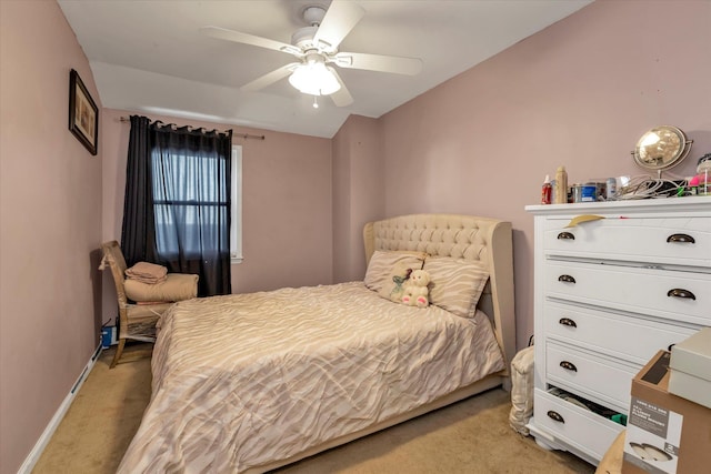 bedroom featuring light colored carpet and ceiling fan