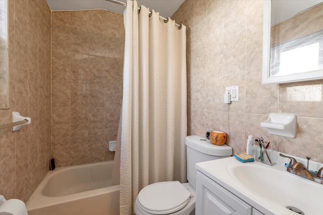 full bathroom featuring toilet, vanity, tile walls, and shower / bath combo