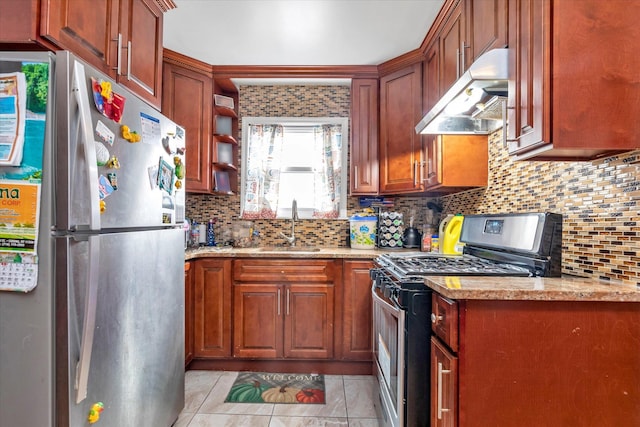 kitchen featuring backsplash, light stone counters, sink, and stainless steel appliances