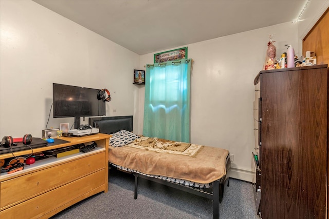 bedroom with dark colored carpet