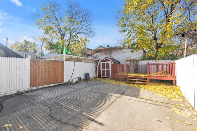 view of patio / terrace featuring a storage shed and a wooden deck