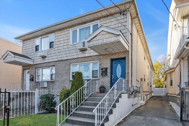 view of front of property featuring an AC wall unit