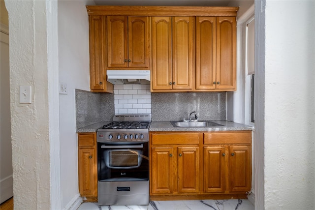 kitchen featuring decorative backsplash, gas stove, and sink