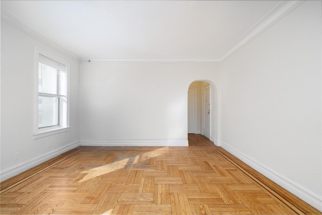 spare room featuring light parquet floors and crown molding