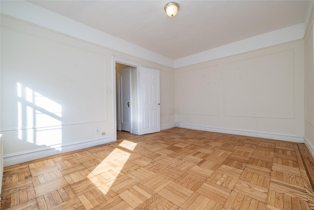 unfurnished room featuring light parquet flooring