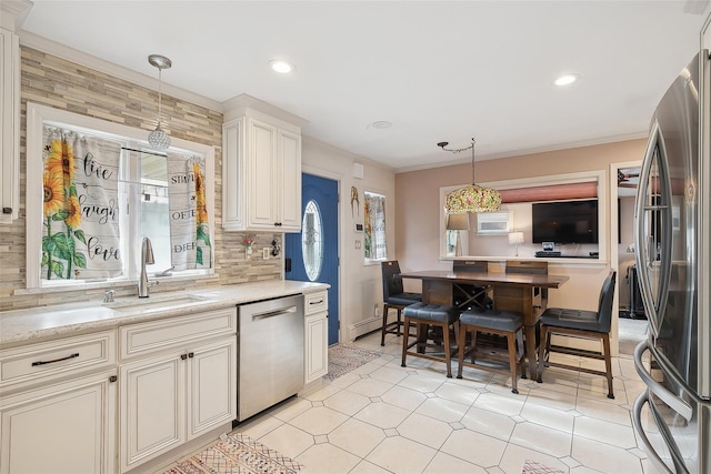 kitchen with light stone countertops, stainless steel appliances, wooden walls, decorative light fixtures, and decorative backsplash