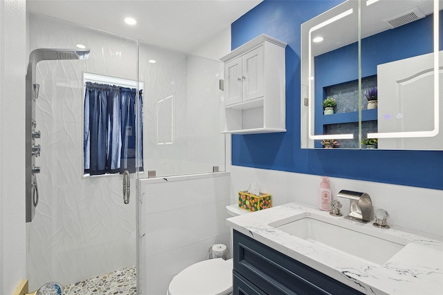 bathroom with vanity, toilet, and walk in shower