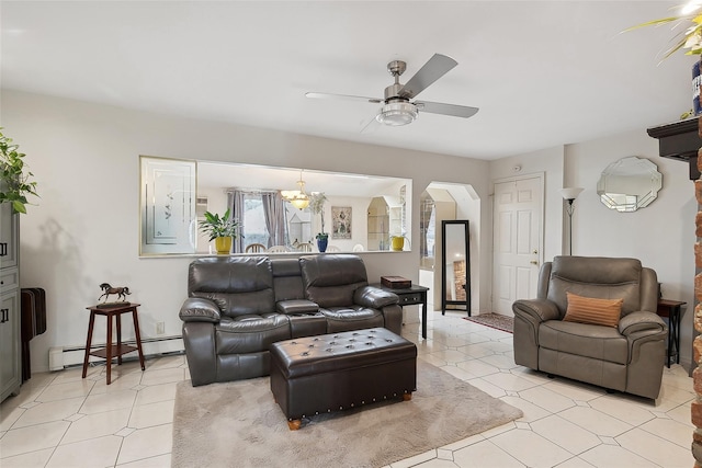 living room featuring ceiling fan with notable chandelier and a baseboard heating unit