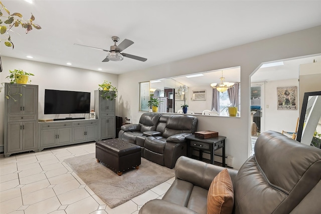 living room featuring a wall mounted air conditioner and ceiling fan with notable chandelier