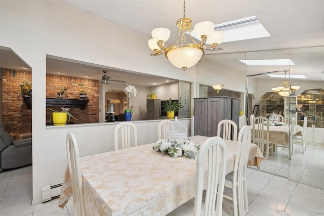 tiled dining space with ceiling fan with notable chandelier, a baseboard radiator, and a skylight