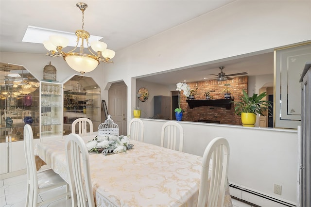 dining space with ceiling fan with notable chandelier and baseboard heating