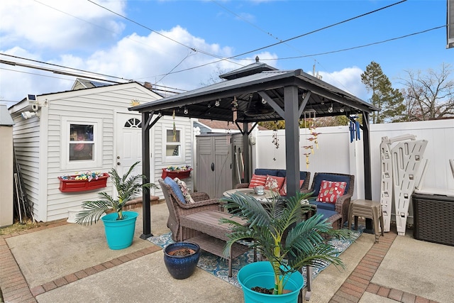 view of patio with outdoor lounge area, a gazebo, and a storage shed