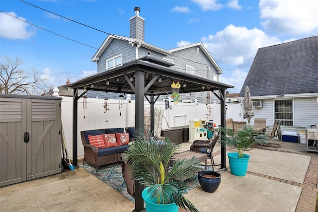 view of patio / terrace featuring a gazebo, outdoor lounge area, a wall mounted air conditioner, and a storage shed