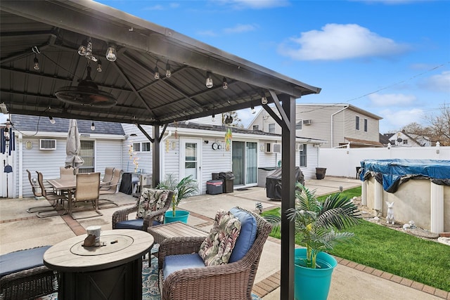 view of patio with a gazebo, ceiling fan, and a covered pool