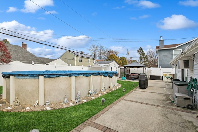 view of yard with a gazebo, a covered pool, and a patio area