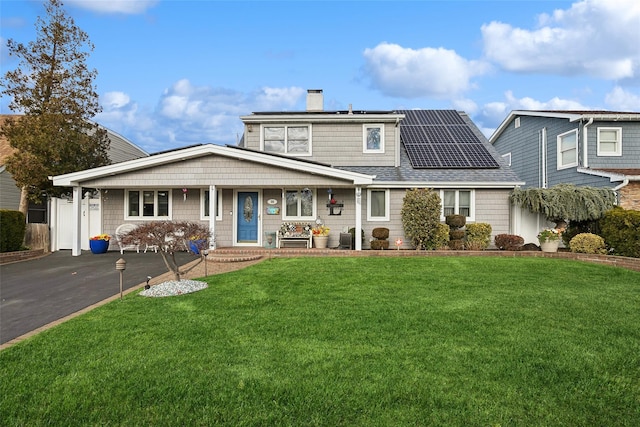 view of front of property featuring solar panels, a porch, and a front lawn