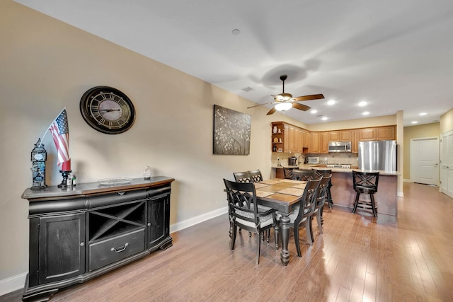 dining area featuring light hardwood / wood-style flooring and ceiling fan