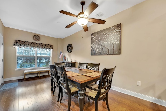 dining room with ceiling fan and hardwood / wood-style flooring