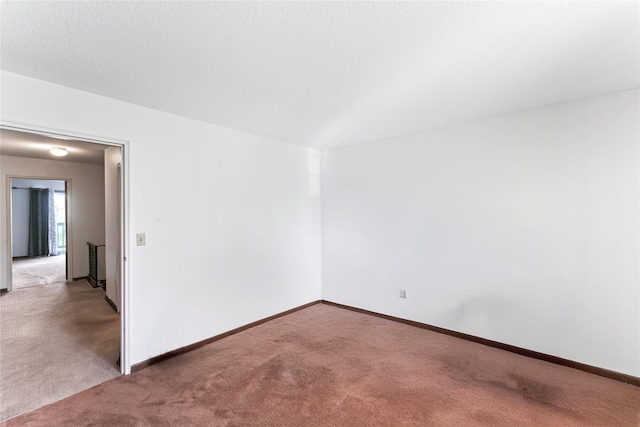 unfurnished room featuring light colored carpet and a textured ceiling