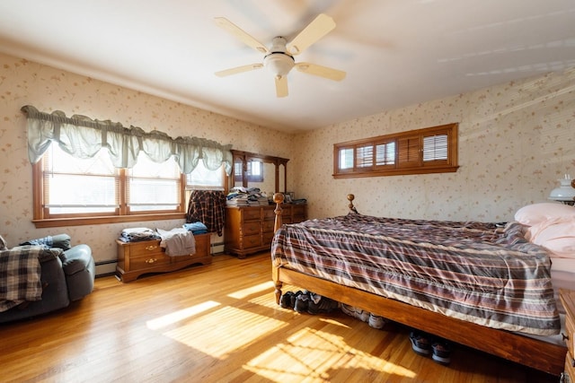 bedroom with light hardwood / wood-style flooring and ceiling fan