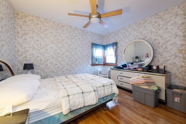 bedroom featuring hardwood / wood-style flooring, ceiling fan, and cooling unit