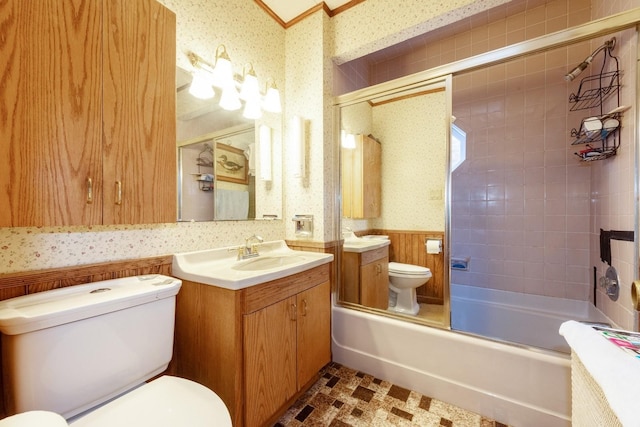 full bathroom with vanity, bath / shower combo with glass door, and toilet