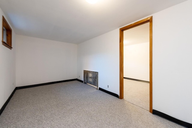 carpeted empty room with radiator