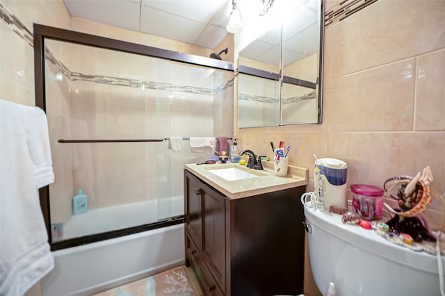 135 Post Ave Unit 5U, Westbury, NY 11590 - full bath featuring tile walls, enclosed tub / shower combo, vanity, and toilet