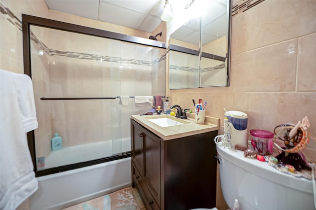 135 Post Ave Unit 5U, Westbury, NY 11590 - full bath with tile walls, enclosed tub / shower combo, vanity, and toilet