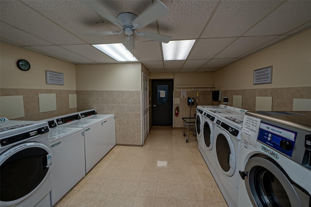 135 Post Ave Unit 5U, Westbury, NY 11590 - community laundry room featuring washer and clothes dryer, tile walls, a ceiling fan, and a wainscoted wall