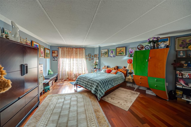 135 Post Ave Unit 5U, Westbury, NY 11590 - bedroom featuring wood finished floors, a textured ceiling, and ornamental molding