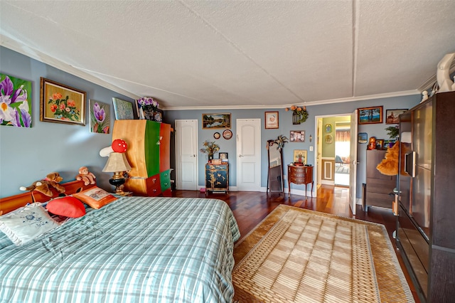 135 Post Ave Unit 5U, Westbury, NY 11590 - bedroom featuring wood finished floors, crown molding, and a textured ceiling