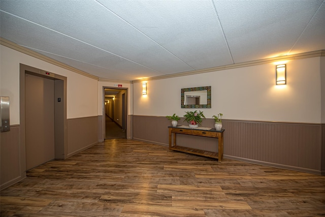 135 Post Ave Unit 5U, Westbury, NY 11590 - hallway featuring elevator, wainscoting, dark wood-type flooring, a textured ceiling, and crown molding