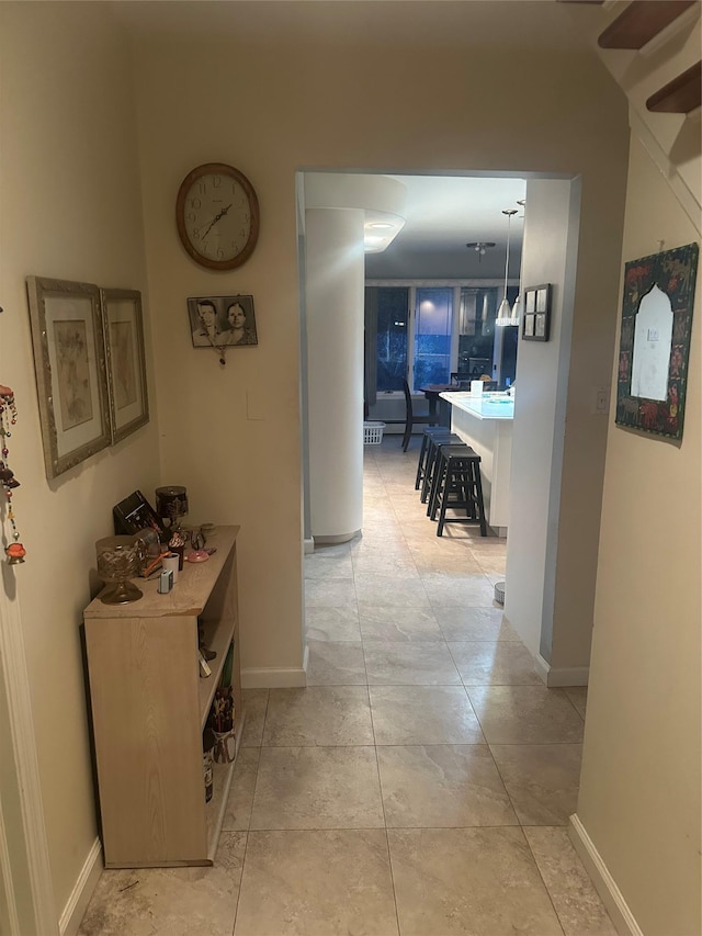 hall with light tile patterned floors