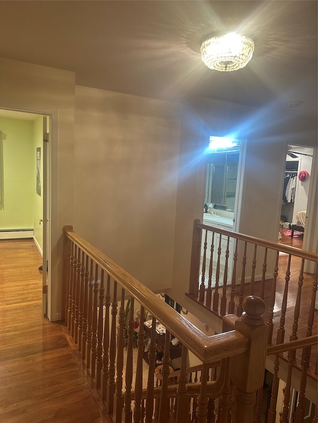 hallway featuring hardwood / wood-style floors and baseboard heating