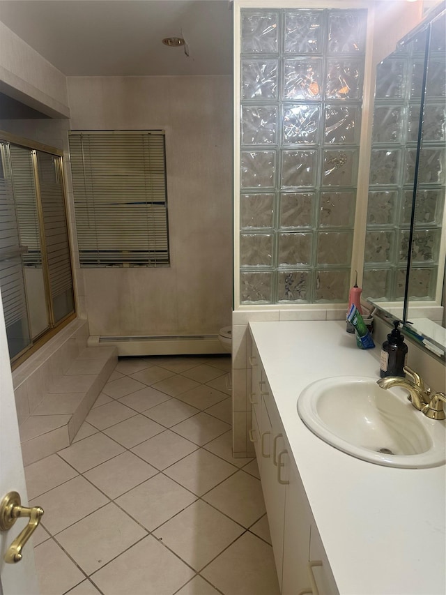 bathroom featuring vanity, a shower, tile patterned floors, toilet, and a baseboard radiator