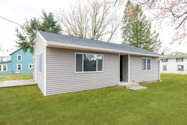 rear view of house featuring a lawn