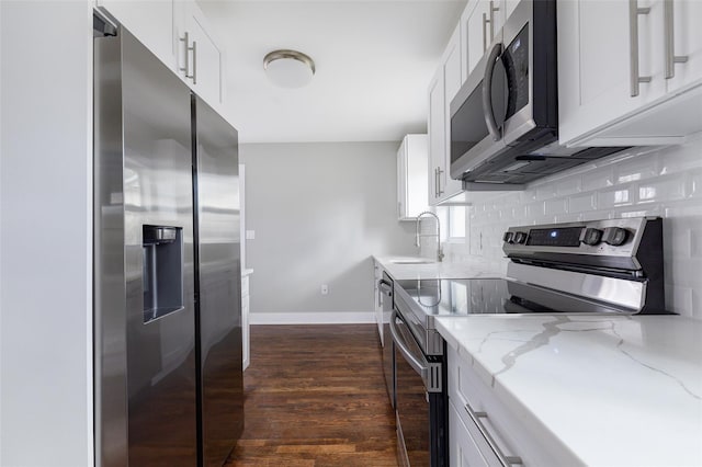 kitchen featuring dark hardwood / wood-style floors, white cabinetry, sink, and appliances with stainless steel finishes